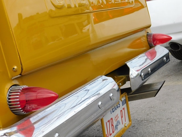 Classic car taillight and chrome bumper detail
