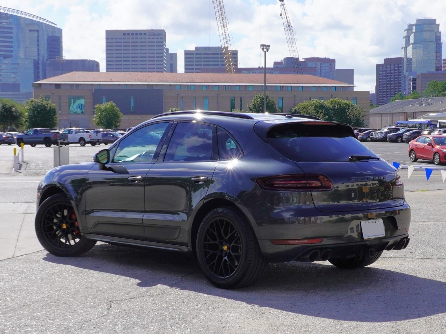 Black Porsche Macan parked urban lot