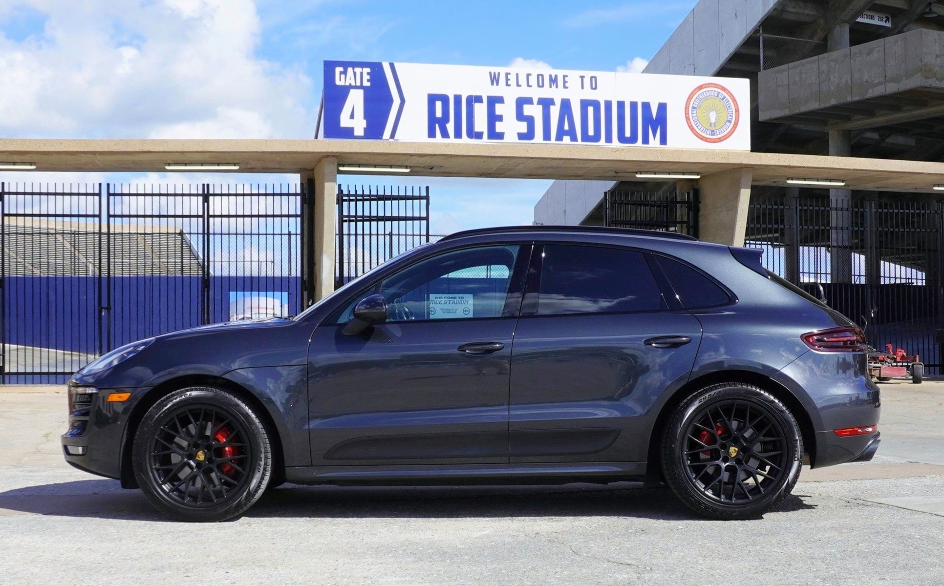 Dark Porsche Macan at Rice Stadium gate